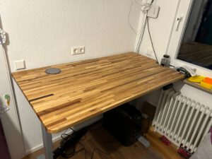 Individuell gefertigte Holzschreibtischplatte mit passgenauer Kontur und Kabeldurchführung
